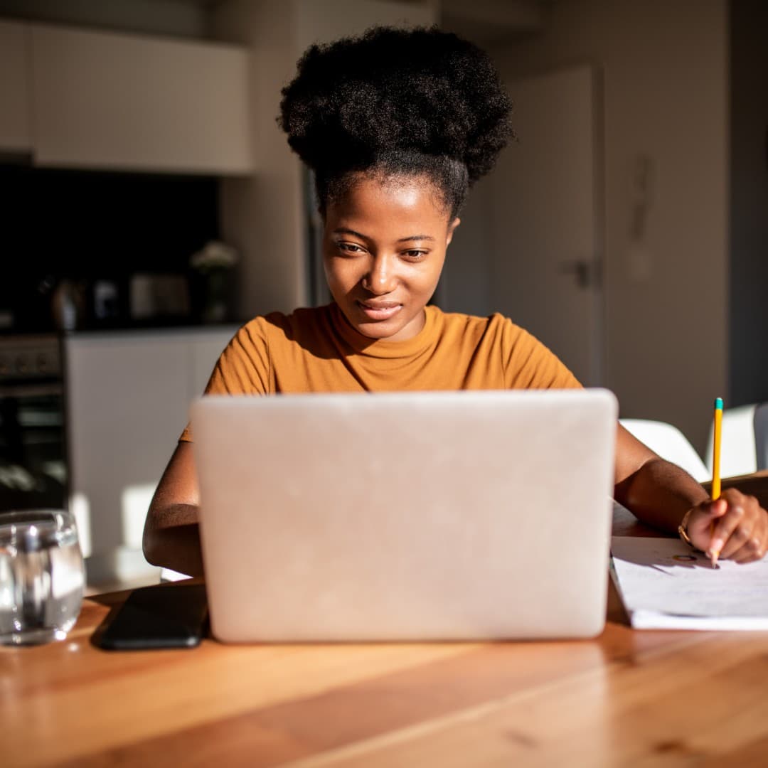 Woman working on laptop at a table